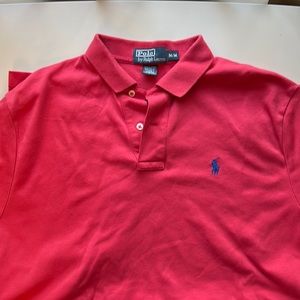 Like new polo size medium color is coral with royal blue polo